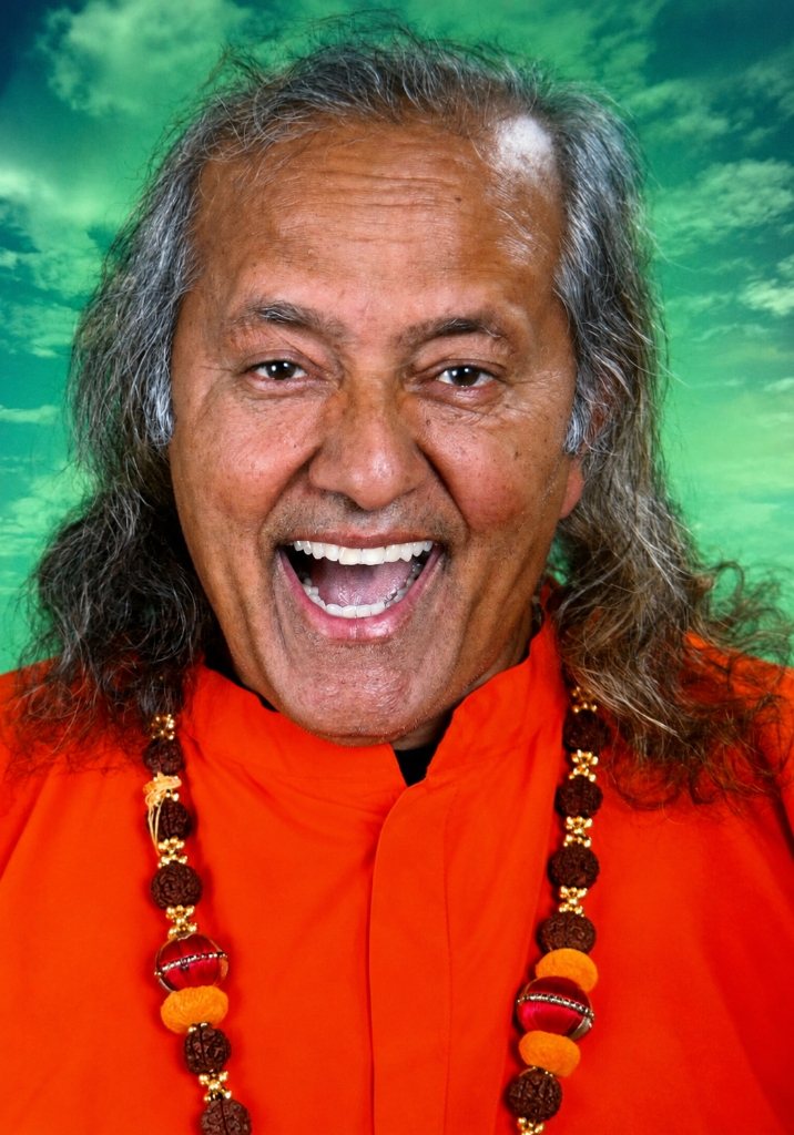 Yogi Ramesh Pandey laughing, wearing orange robes and a mala