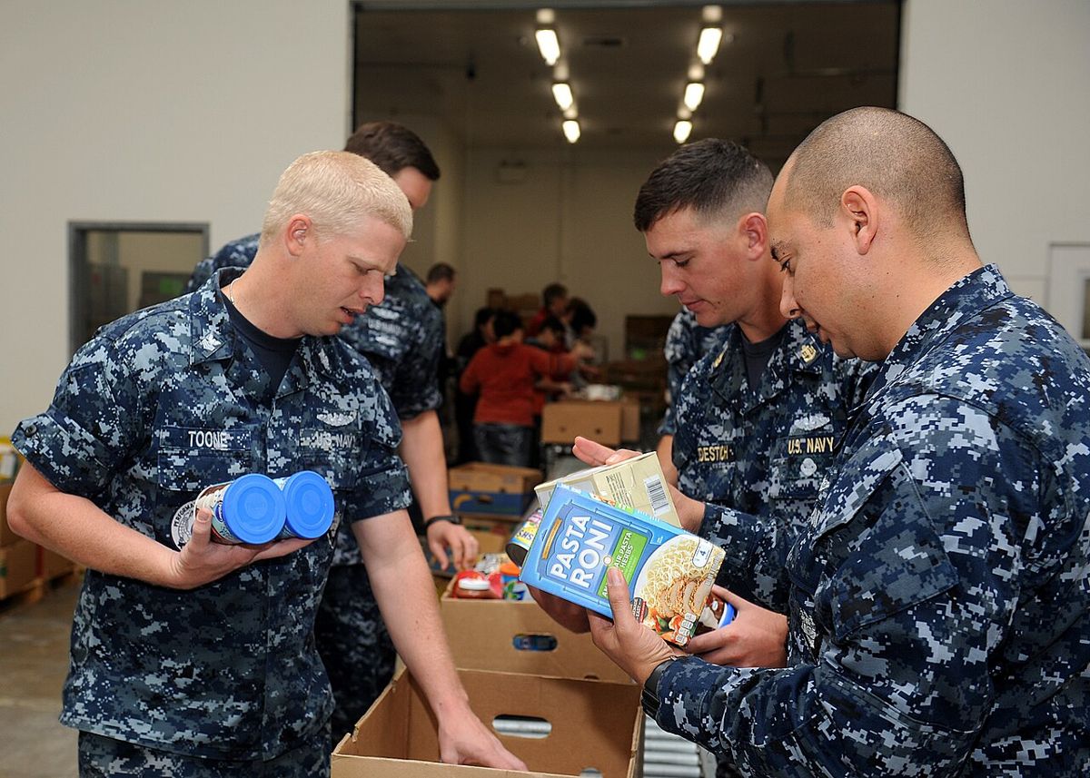 Volunteers sorting donated food at a food bank in San Diego